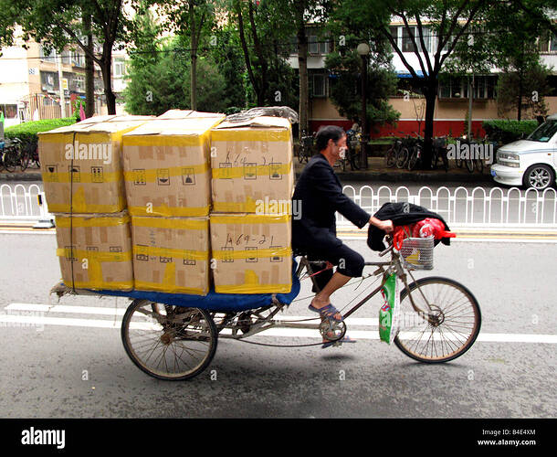 a-man-carries-a-large-load-of-boxes-on-a-bicycle-in-beijing-china-B4E4XM